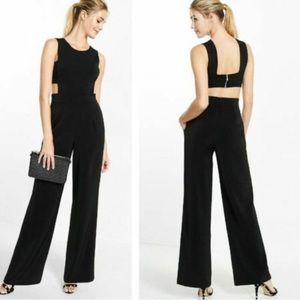 Black romper with pockets. Cut out back. Zipper detail.